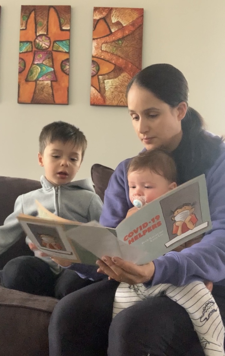 Dr. Diana Pontell reads "COVID-19 Helpers" to her children.